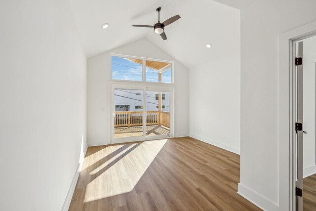 unfurnished living room with light hardwood / wood-style floors, vaulted ceiling, and ceiling fan