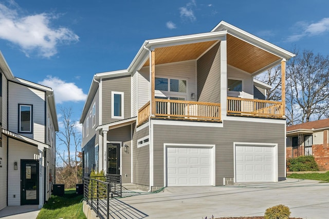 view of front of home with a balcony, a garage, and cooling unit