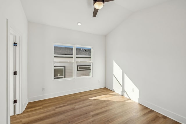 empty room featuring hardwood / wood-style floors, ceiling fan, and lofted ceiling