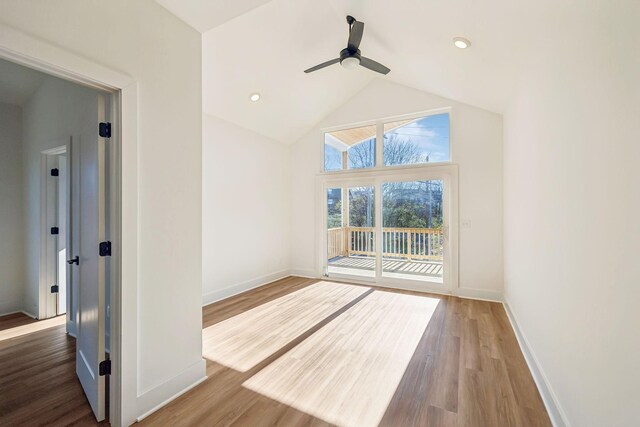 interior space with ceiling fan, vaulted ceiling, and hardwood / wood-style flooring