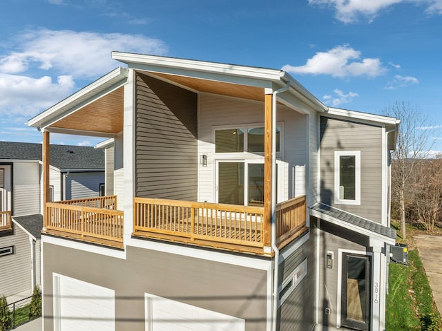 exterior space featuring a garage and a balcony