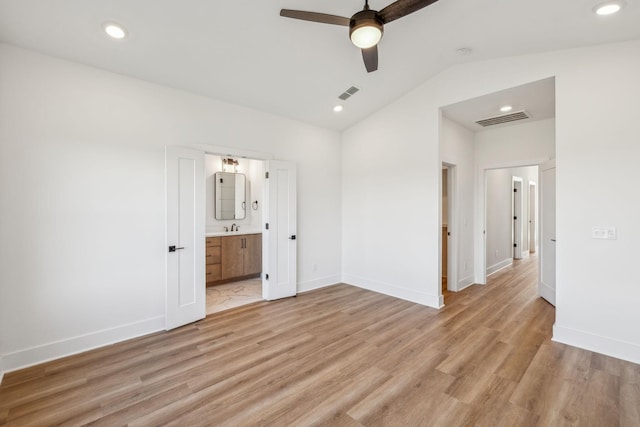 unfurnished bedroom featuring ensuite bathroom, ceiling fan, sink, light hardwood / wood-style flooring, and lofted ceiling