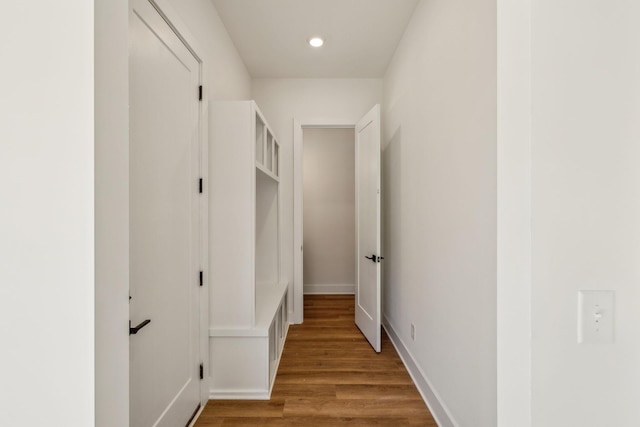 hallway with hardwood / wood-style flooring