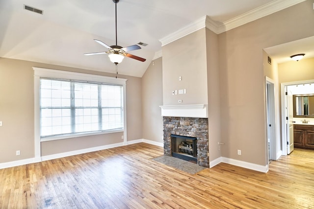 unfurnished living room with ceiling fan, a fireplace, lofted ceiling, and light hardwood / wood-style flooring