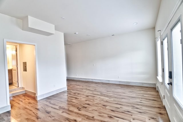 spare room with light wood-type flooring