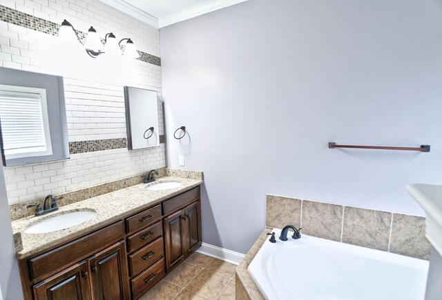 bathroom featuring tile patterned floors, vanity, crown molding, and a bathing tub