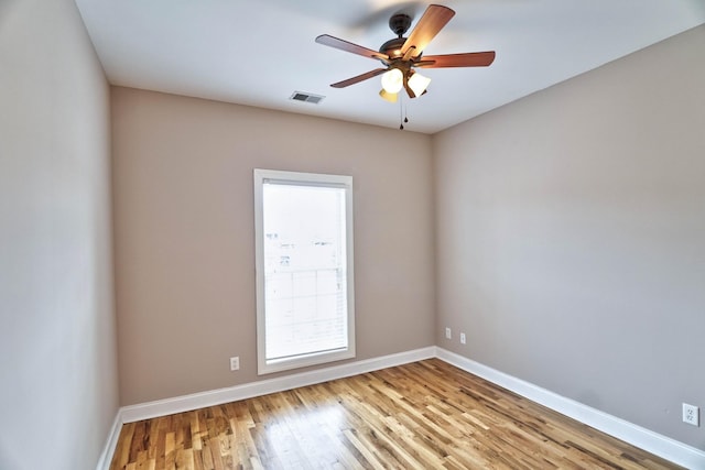 empty room with ceiling fan and light wood-type flooring