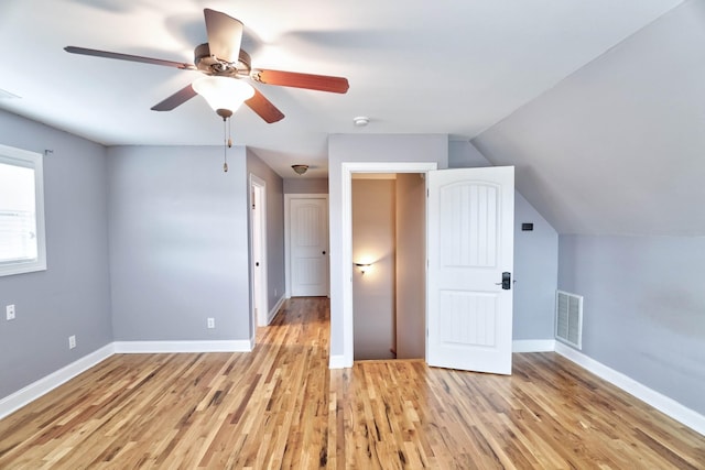 additional living space with ceiling fan, light hardwood / wood-style flooring, and vaulted ceiling