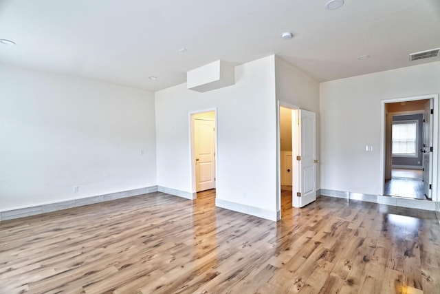 spare room featuring light hardwood / wood-style floors