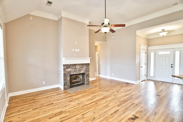 unfurnished living room with ornamental molding, ceiling fan, light hardwood / wood-style flooring, a fireplace, and lofted ceiling