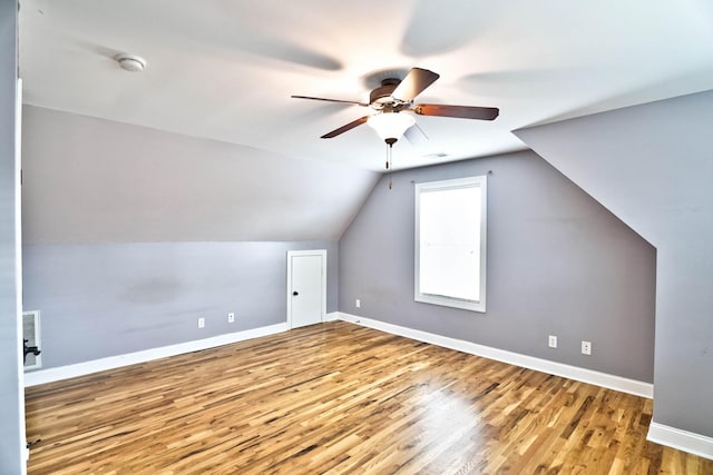 additional living space featuring hardwood / wood-style flooring, ceiling fan, and lofted ceiling