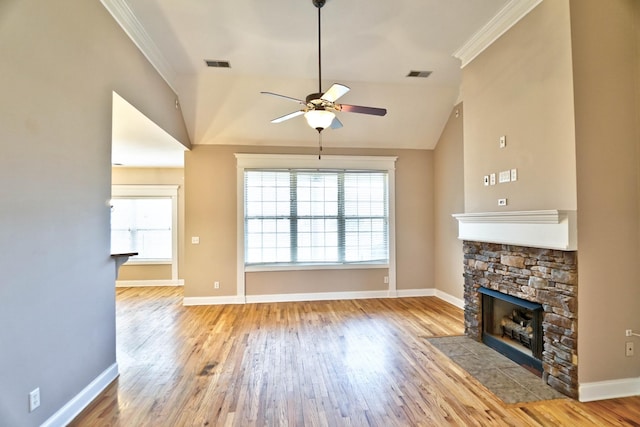 unfurnished living room with ceiling fan, crown molding, light hardwood / wood-style flooring, a fireplace, and lofted ceiling