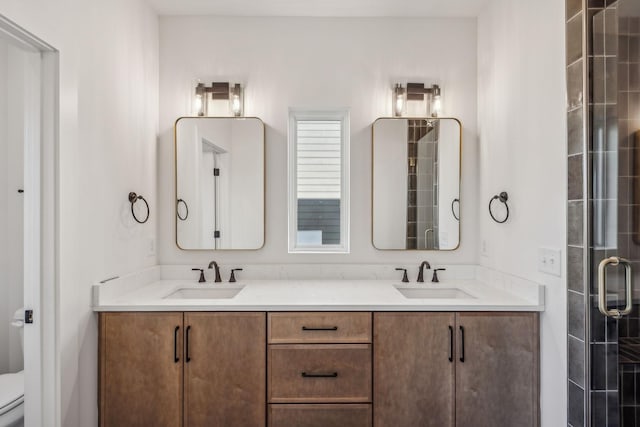 bathroom featuring vanity, toilet, and an enclosed shower