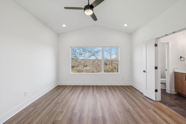 unfurnished bedroom with ceiling fan, ensuite bathroom, light hardwood / wood-style floors, and lofted ceiling