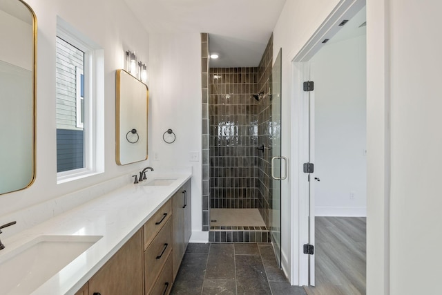 bathroom featuring vanity and a shower with shower door