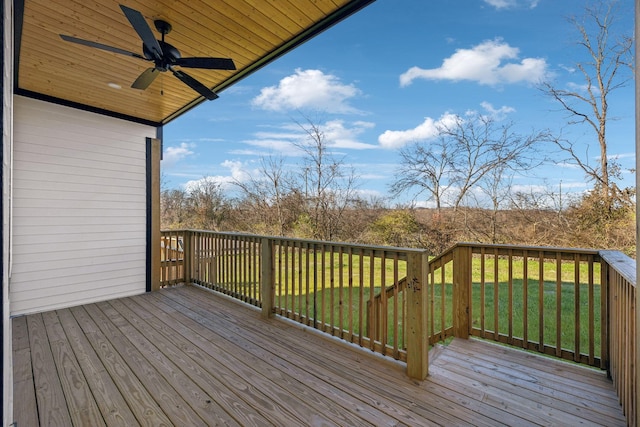 wooden terrace featuring a lawn and ceiling fan