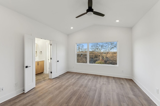 unfurnished bedroom with light hardwood / wood-style floors, ensuite bath, ceiling fan, and lofted ceiling