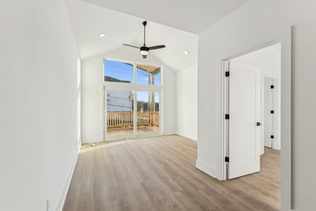 unfurnished room featuring ceiling fan, light hardwood / wood-style flooring, and vaulted ceiling