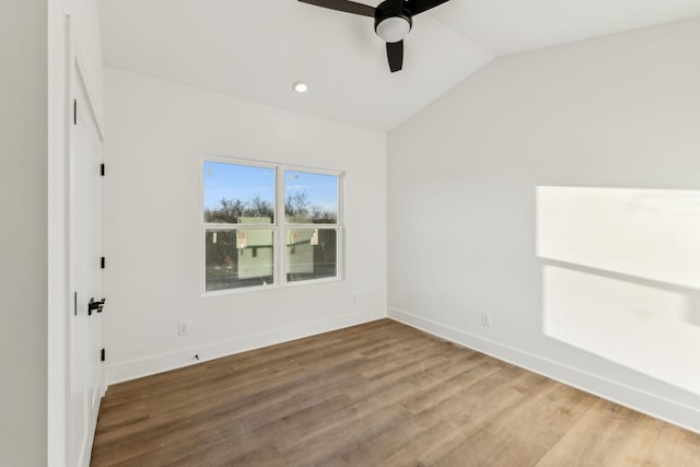 spare room with ceiling fan, hardwood / wood-style floors, and lofted ceiling