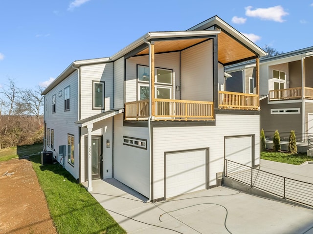 view of front of property with central AC unit, a garage, and a balcony