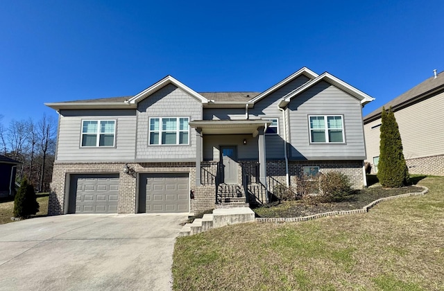 bi-level home with a front yard and a garage