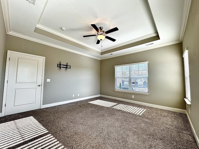 empty room featuring carpet flooring, a raised ceiling, and ceiling fan