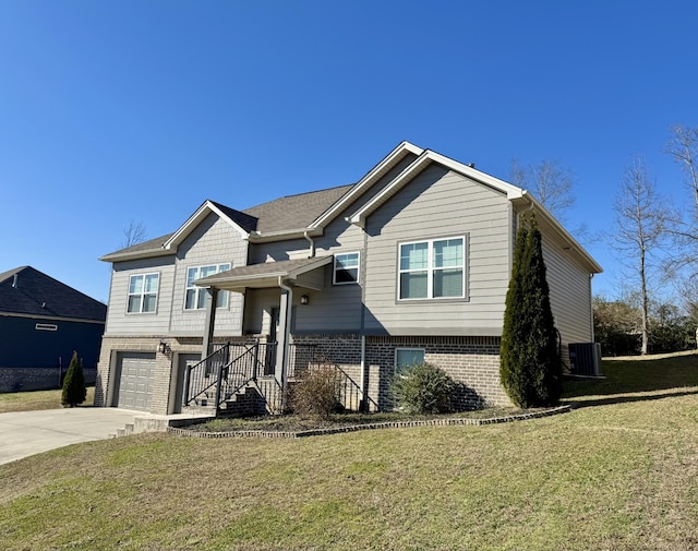 view of front facade featuring central AC, a front yard, and a garage