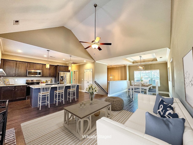 living room featuring vaulted ceiling, ceiling fan, crown molding, and dark hardwood / wood-style floors