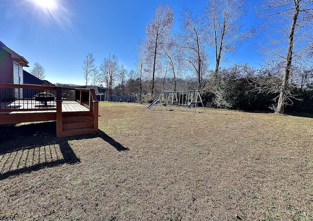 view of yard with a playground and a wooden deck