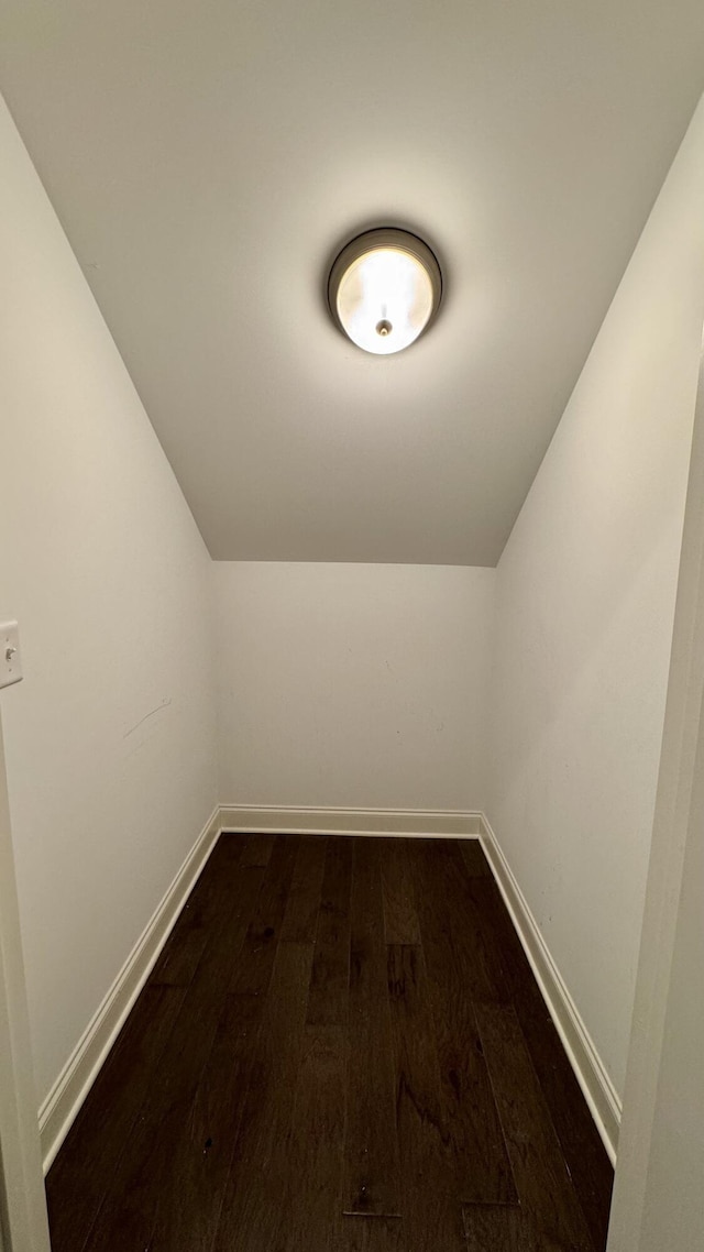 additional living space featuring dark hardwood / wood-style flooring and vaulted ceiling