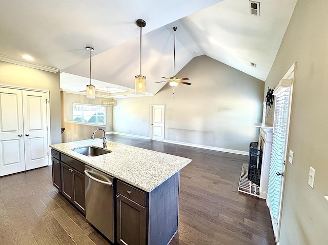 kitchen with ceiling fan, dishwasher, sink, a brick fireplace, and pendant lighting