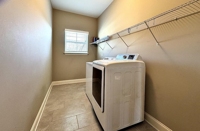 washroom with independent washer and dryer and light tile patterned floors