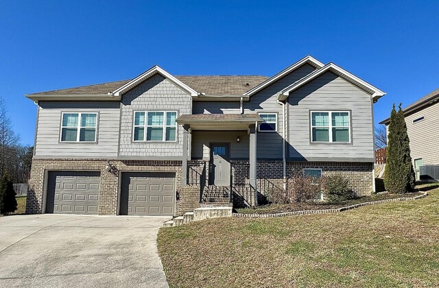 view of front of property with a garage and a front lawn