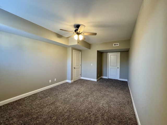 unfurnished bedroom featuring dark colored carpet and ceiling fan