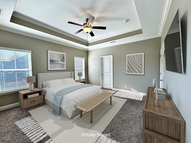 carpeted bedroom featuring ceiling fan, a raised ceiling, and ornamental molding