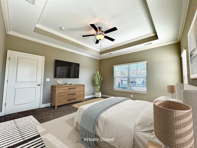 bedroom with ceiling fan, a raised ceiling, and ornamental molding