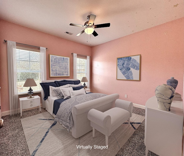 bedroom featuring multiple windows, light carpet, and ceiling fan