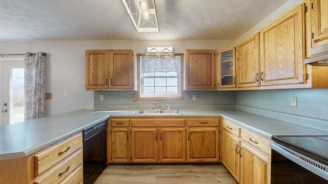 kitchen with dishwasher, sink, a textured ceiling, light hardwood / wood-style floors, and kitchen peninsula