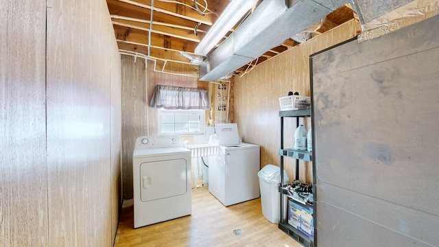 laundry room with washer and dryer and light hardwood / wood-style flooring