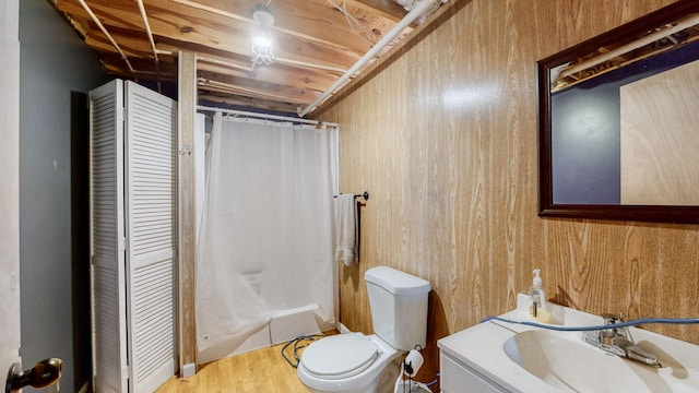 bathroom with vanity, toilet, walk in shower, and wooden walls