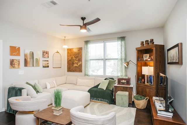 living room featuring ceiling fan and dark hardwood / wood-style flooring