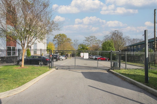 view of gate with a yard