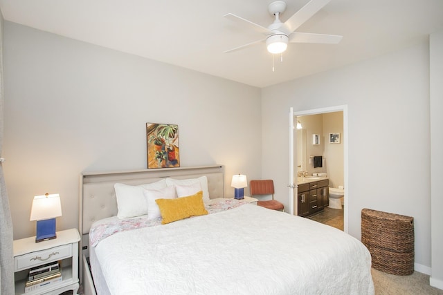 carpeted bedroom featuring ceiling fan and ensuite bathroom