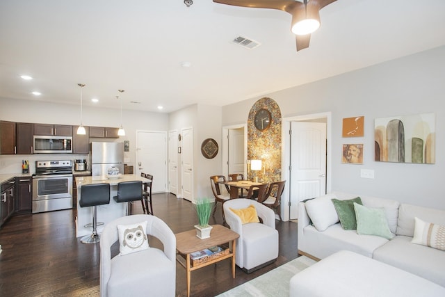 living room with ceiling fan and dark hardwood / wood-style floors