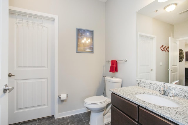 bathroom with tile patterned floors, vanity, and toilet