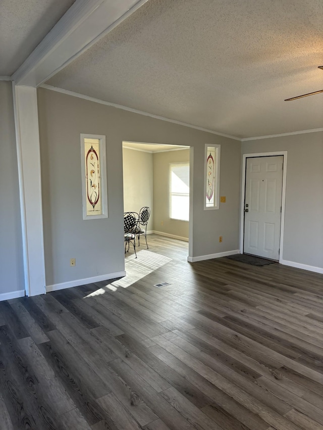 foyer entrance featuring crown molding, a textured ceiling, and dark wood-type flooring