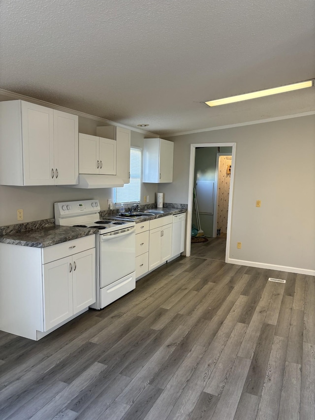 kitchen featuring white cabinets, dark hardwood / wood-style floors, white appliances, and a textured ceiling