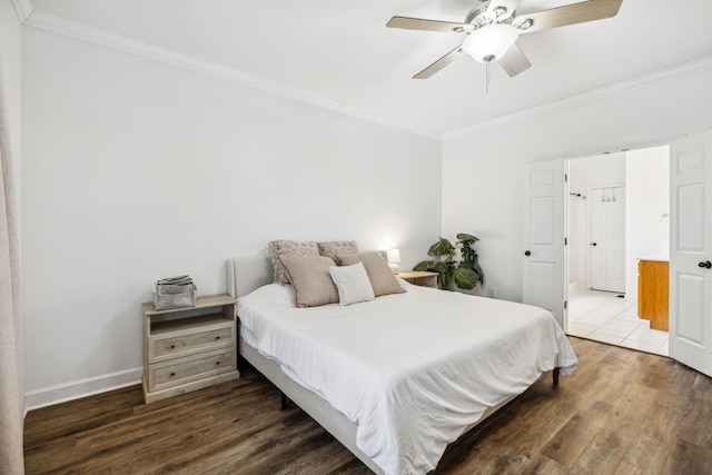 bedroom with crown molding, ceiling fan, and dark hardwood / wood-style flooring