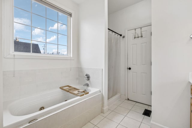 bathroom with tile patterned floors, shower with separate bathtub, and vanity