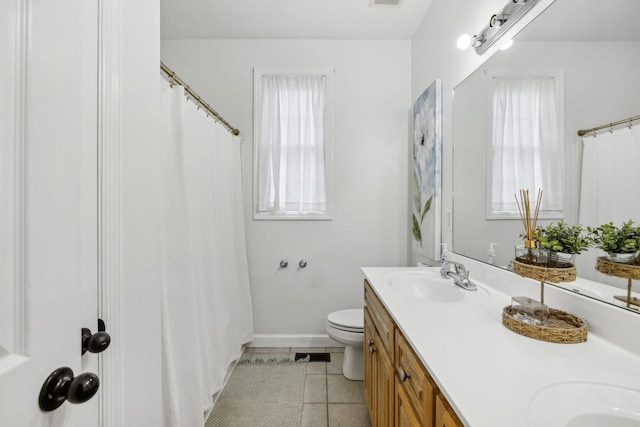 bathroom featuring tile patterned floors, toilet, and vanity